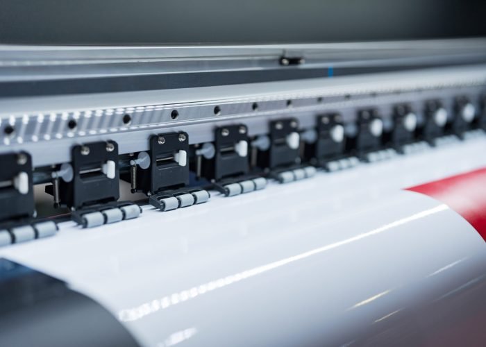 Close-up of large format printer heads in action, Detailed view of modern large format printer heads working on white media